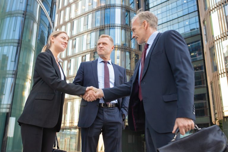 business-people-meeting-city-shaking-hands